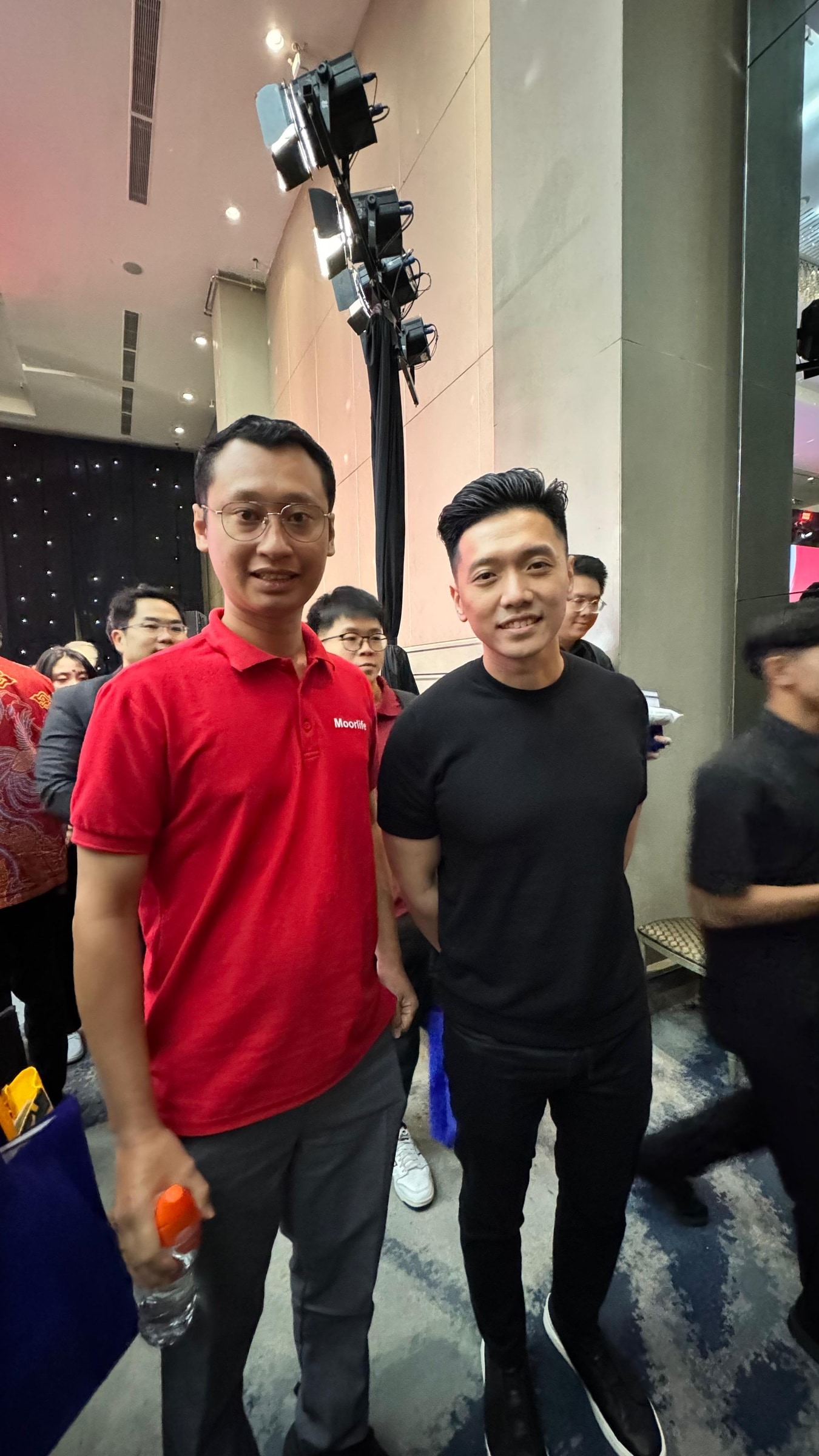 Olisiang standing beside another attendee at a professional event.