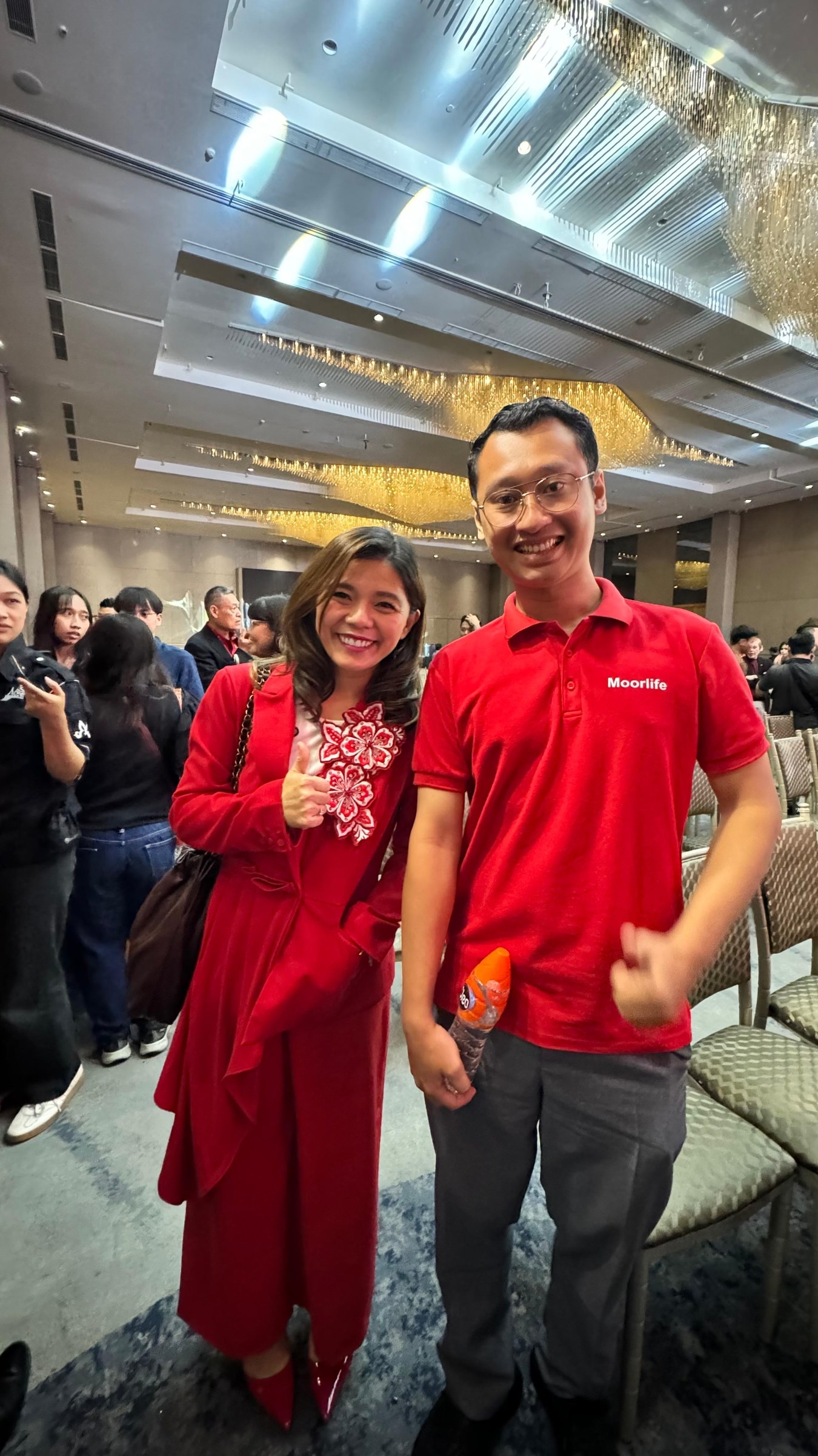 Olisiang standing beside another attendee at a professional event.