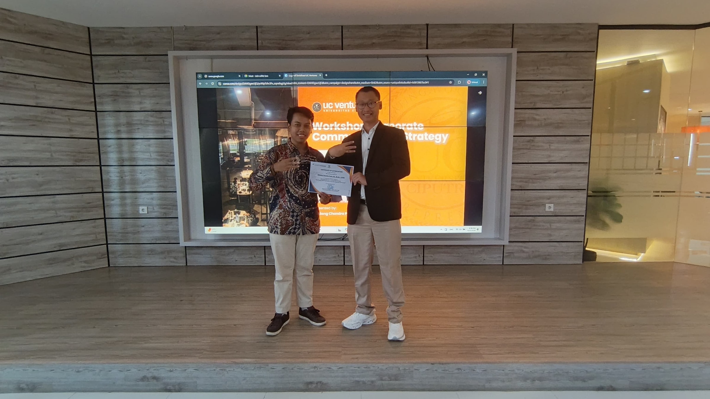 Olisiang in certificate handover documentation at Universitas Ciputra.